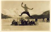 ACROBATIC SKATER LEAPING ABOVE A ROW OF MUFFLED LADIES (postcard)