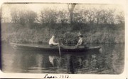 COUPLE IN A ROWING BOAT ON GENTLE WATER POSTCARD
