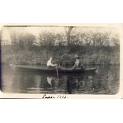 COUPLE IN A ROWING BOAT ON GENTLE WATER POSTCARD