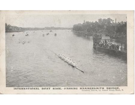 INTERNATIONAL BOAT RACE - PASSING HAMMERSMITH BRIDGE 1906 POSTCARD